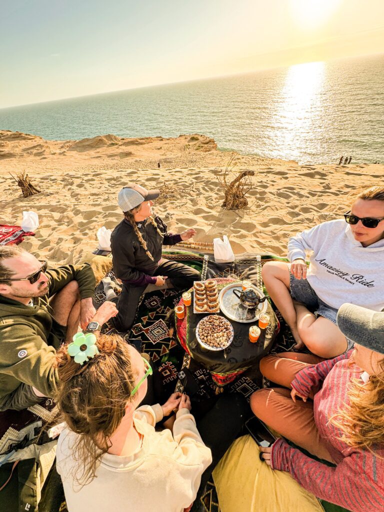 Picnic on the beach with surf camp friends at golden hour